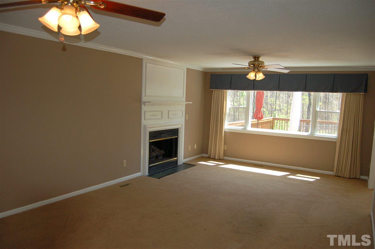 300 Barclay Road Durham, NC 27712 - Photo 12 of 25 an empty room with windows and chandelier fan