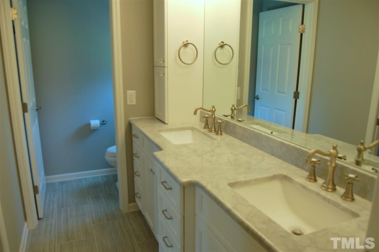 300 Barclay Road Durham, NC 27712 - Photo 16 of 25 a bathroom with a granite countertop sink and a mirror