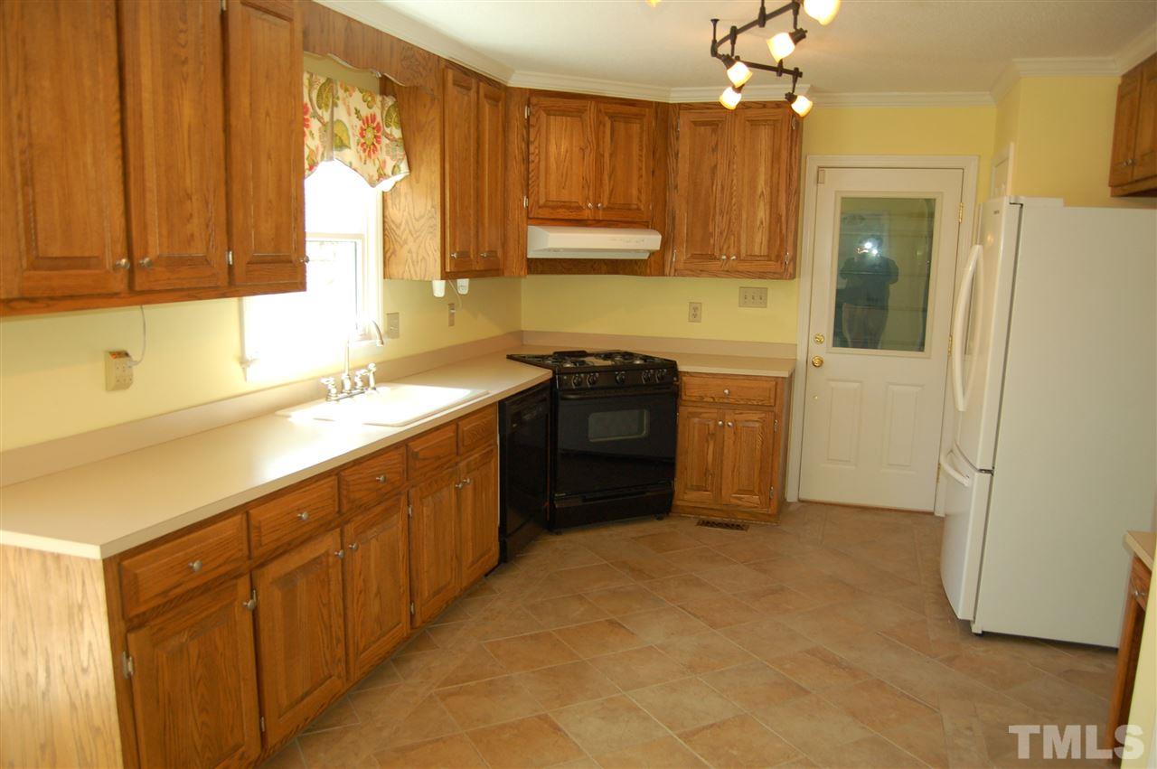 300 Barclay Road Durham, NC 27712 - Photo 6 of 25 a kitchen with stainless steel appliances granite countertop a sink a stove and a refrigerator