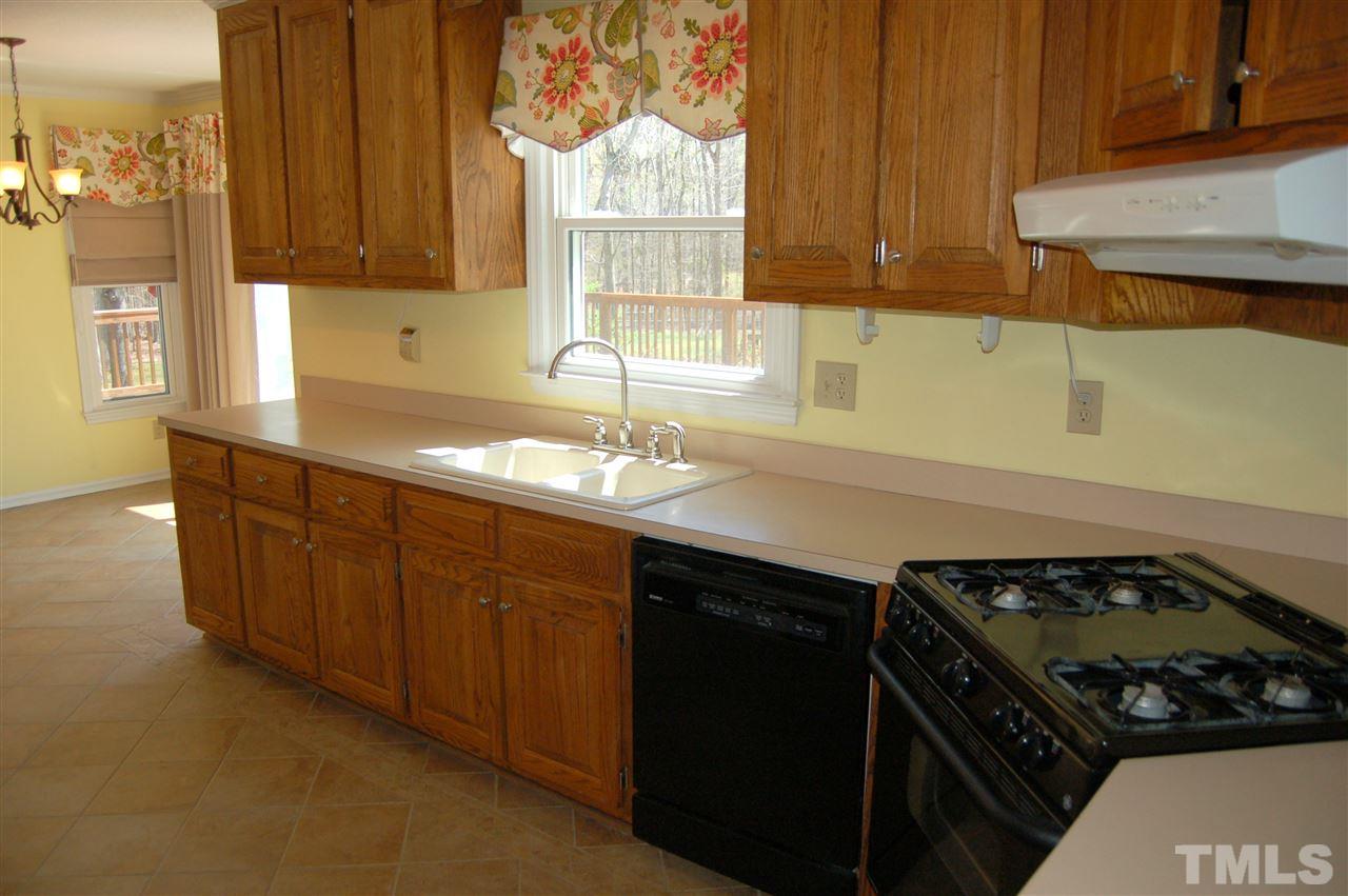 300 Barclay Road Durham, NC 27712 - Photo 7 of 25 a kitchen with granite countertop a sink stove and cabinets