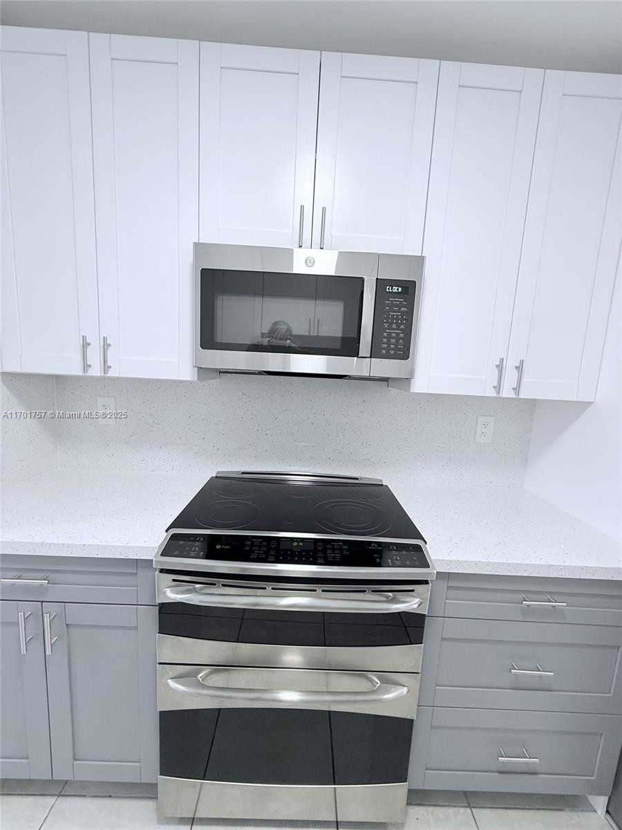 956 West 68th Street Hialeah, FL 33014 - Photo 11 of 21 a kitchen with appliances and cabinets