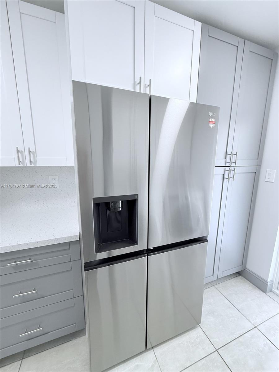 956 West 68th Street Hialeah, FL 33014 - Photo 12 of 21 a kitchen with metallic refrigerator freezer and a dishwasher