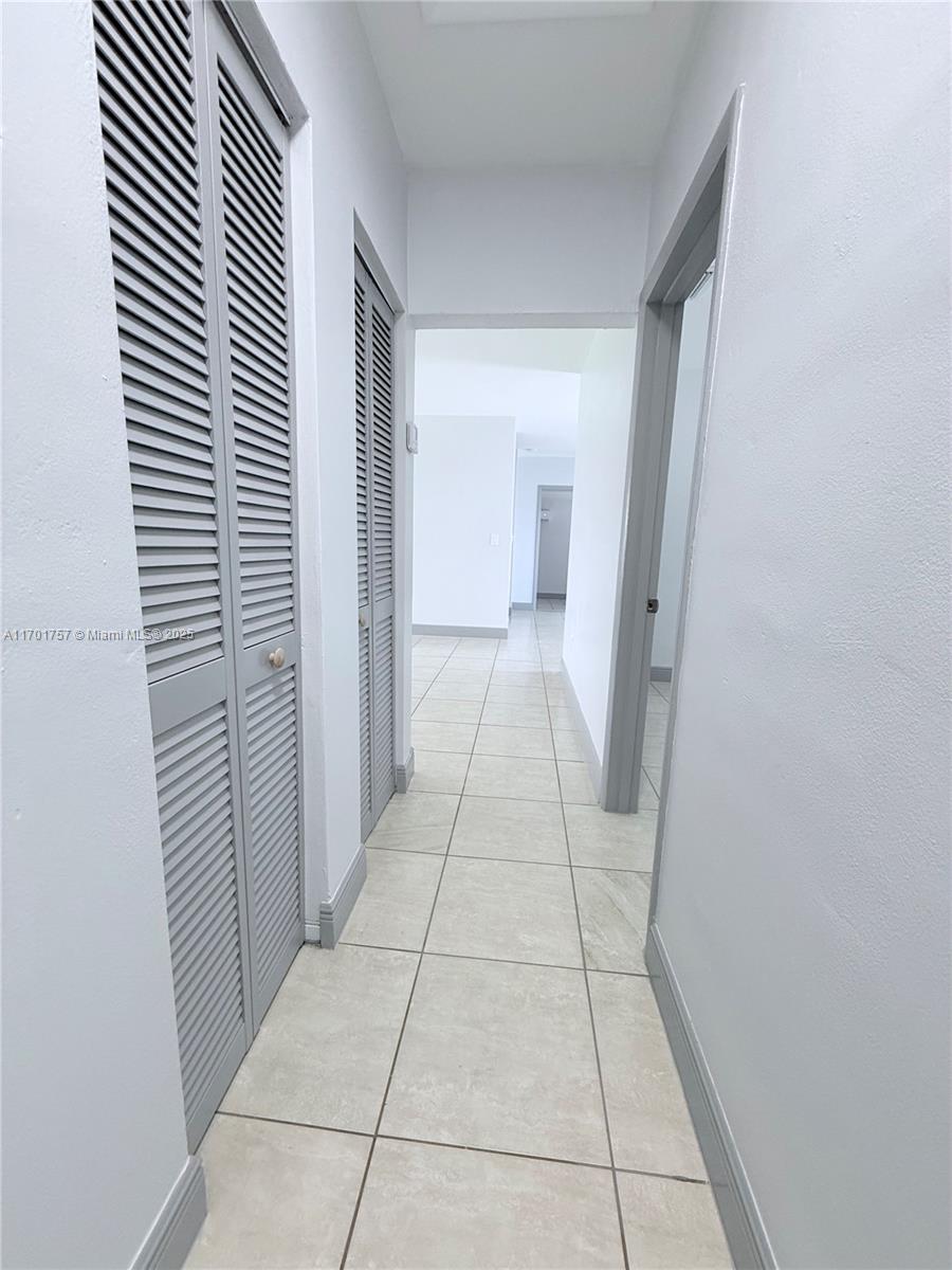 956 West 68th Street Hialeah, FL 33014 - Photo 15 of 21 a view of a hallway in a house
