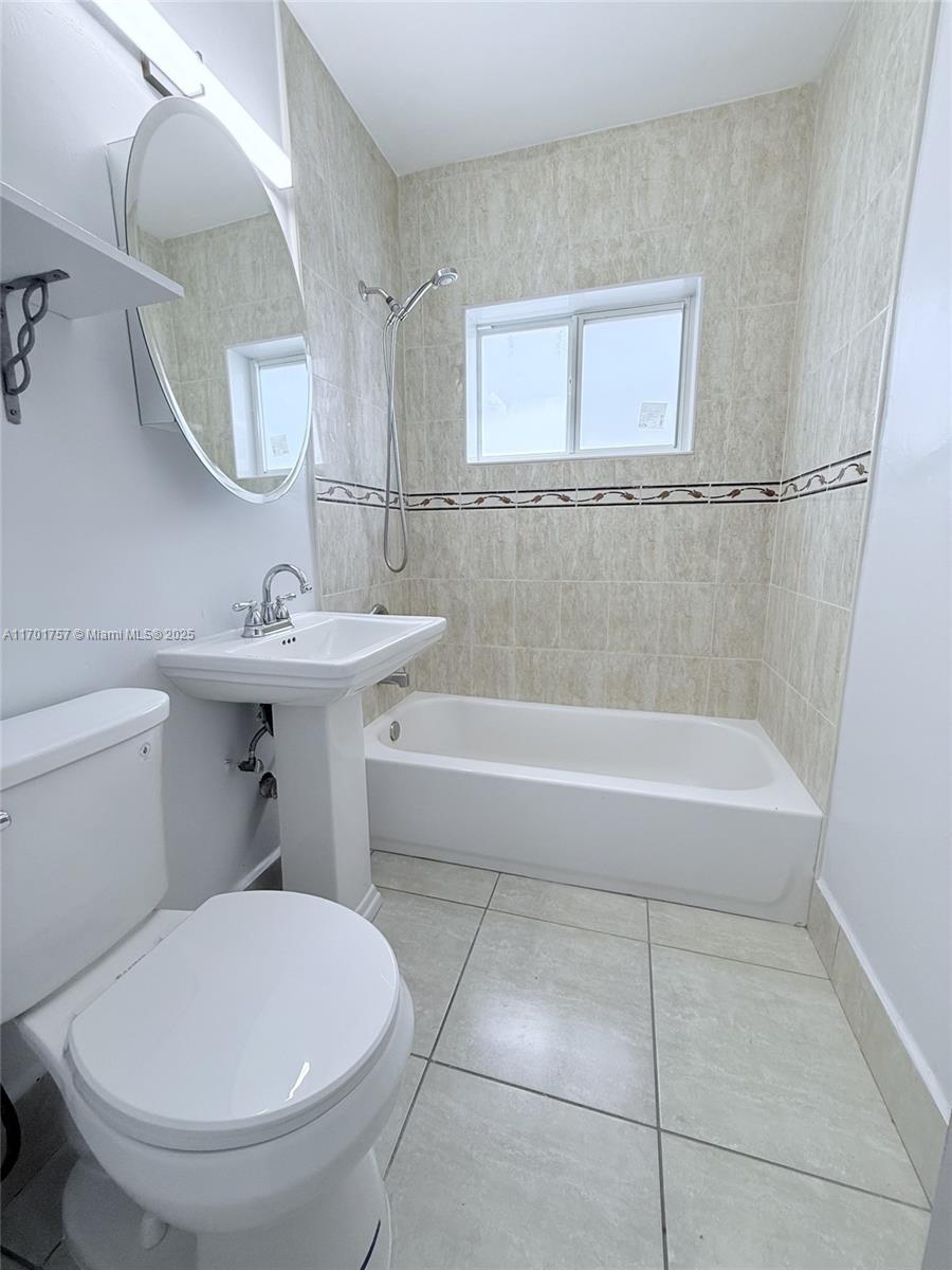 956 West 68th Street Hialeah, FL 33014 - Photo 19 of 21 a bathroom with a sink a toilet and a mirror