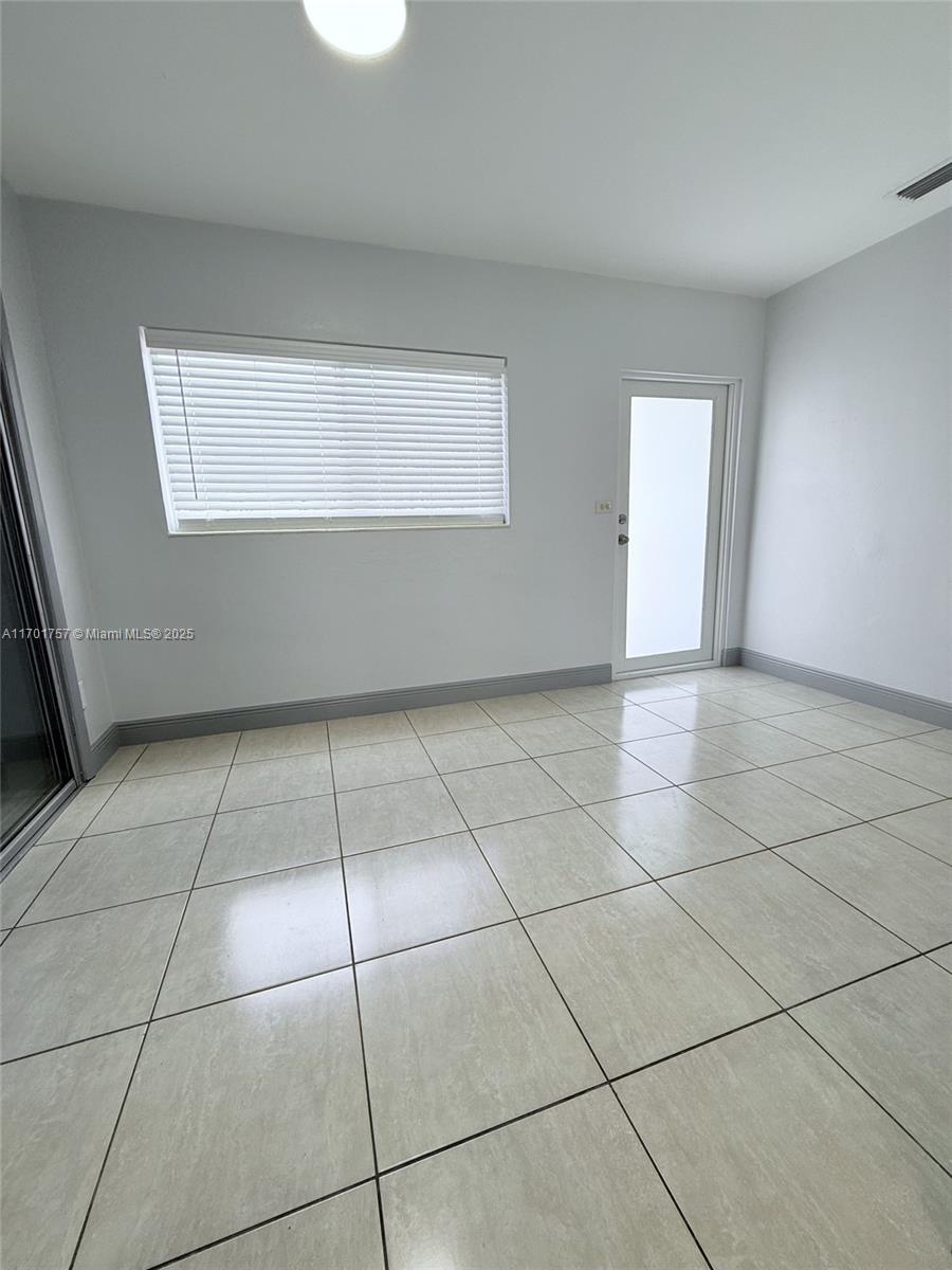 956 West 68th Street Hialeah, FL 33014 - Photo 2 of 21 a view of a livingroom with an empty space and a window