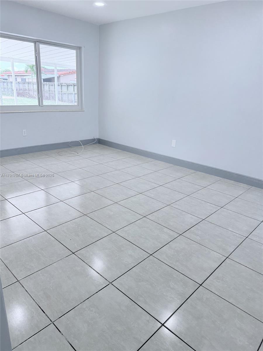 956 West 68th Street Hialeah, FL 33014 - Photo 3 of 21 an empty room with windows