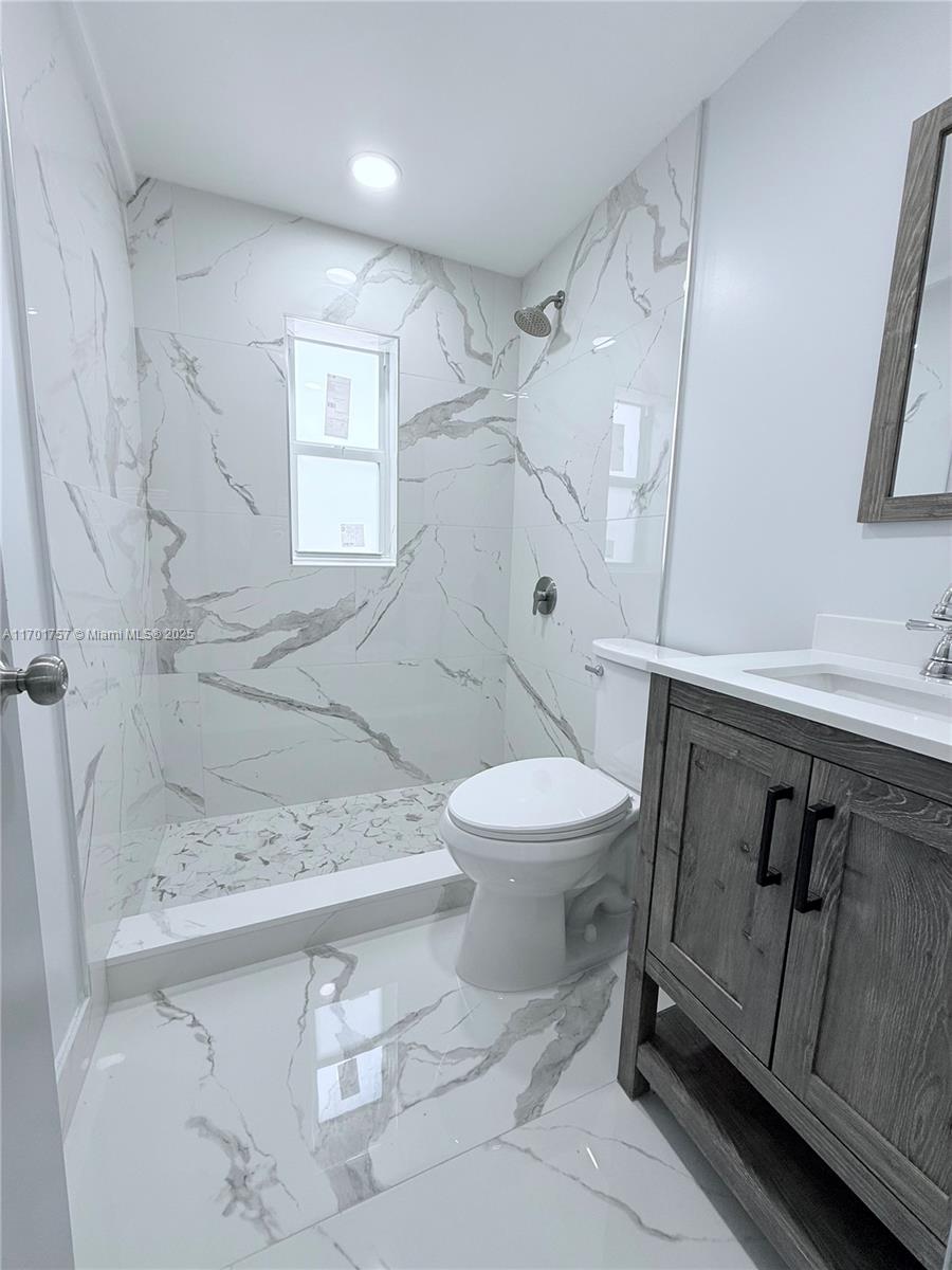 956 West 68th Street Hialeah, FL 33014 - Photo 8 of 21 a bathroom with a sink a toilet and shower