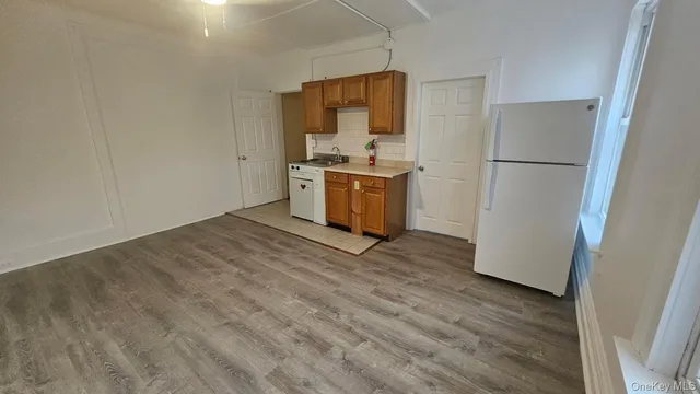 a kitchen with a refrigerator and a stove top oven