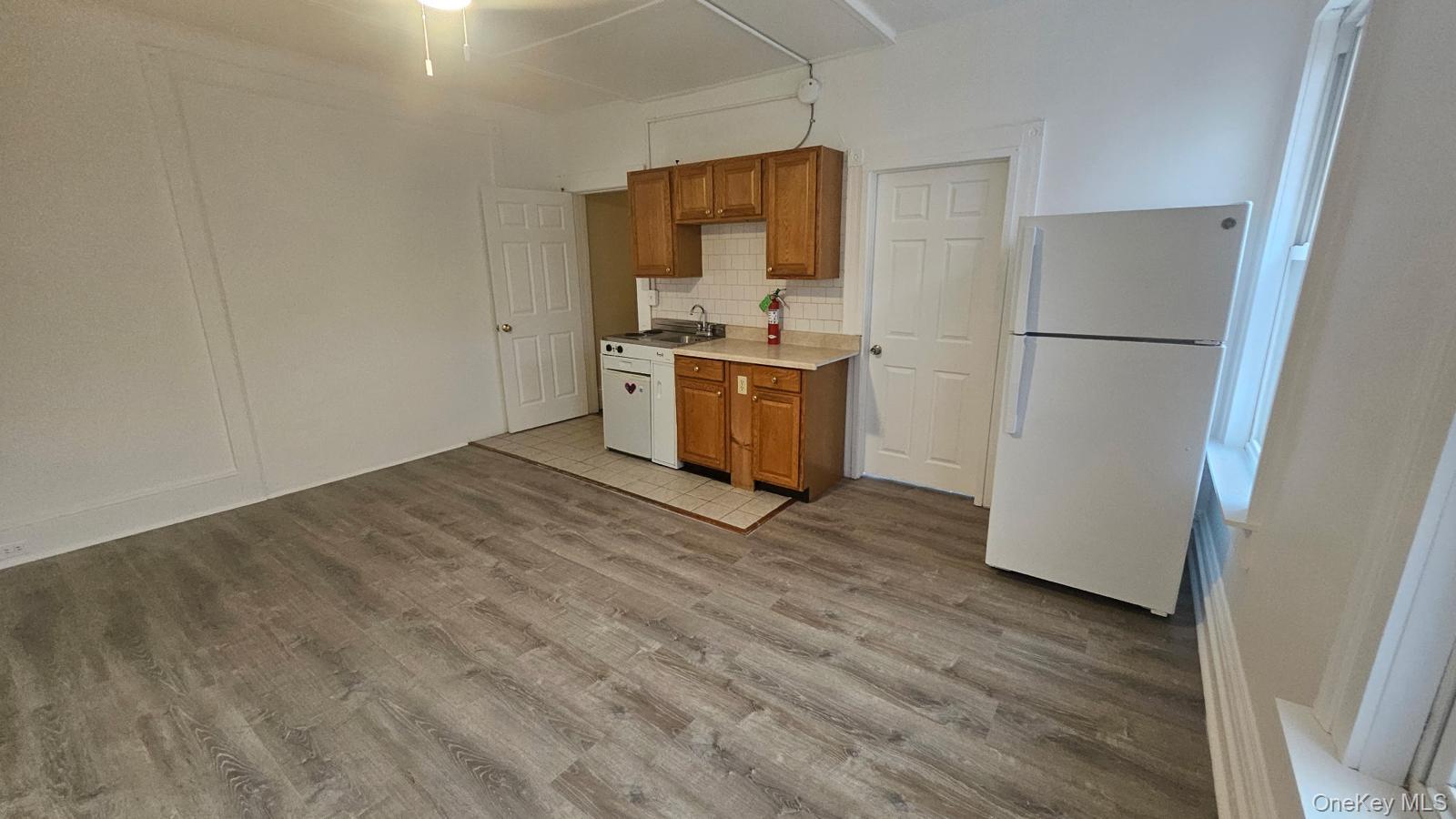 455 Main Street, Unit 1 Beacon, NY 12508 - Photo 3 of 8 a kitchen with a refrigerator and a stove top oven