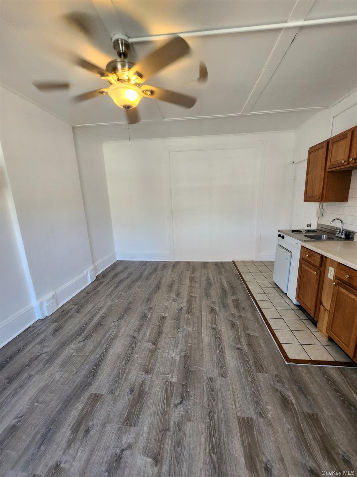 455 Main Street, Unit 1 Beacon, NY 12508 - Photo 4 of 8 a view of a room with wooden floor and flat screen tv