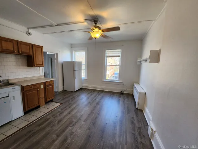 a view of a kitchen with a sink cabinets and wooden floor