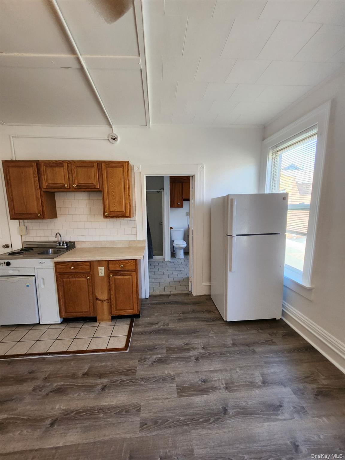 455 Main Street, Unit 1 Beacon, NY 12508 - Photo 6 of 8 a kitchen with stainless steel appliances a refrigerator a sink a stove a microwave a counter top and oven