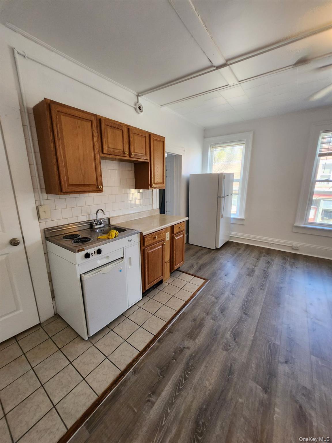 455 Main Street, Unit 1 Beacon, NY 12508 - Photo 8 of 8 a kitchen with granite countertop a stove top oven a sink dishwasher and a refrigerator with wooden floor