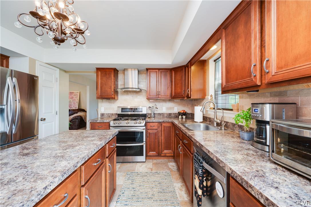 238 Longview Drive Reading, PA 19608 - Photo 14 of 43 a kitchen with stainless steel appliances granite countertop a stove a sink dishwasher and a refrigerator