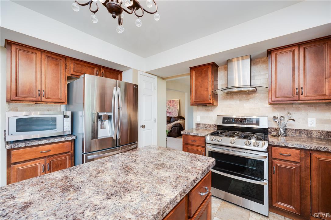 238 Longview Drive Reading, PA 19608 - Photo 15 of 43 a kitchen with stainless steel appliances granite countertop a stove refrigerator sink and cabinets