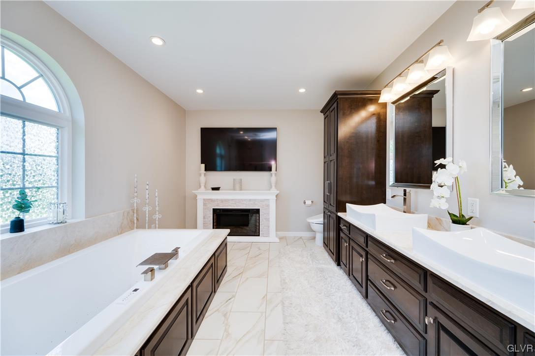 238 Longview Drive Reading, PA 19608 - Photo 26 of 43 a hall with a sink a large mirror and a wooden floor