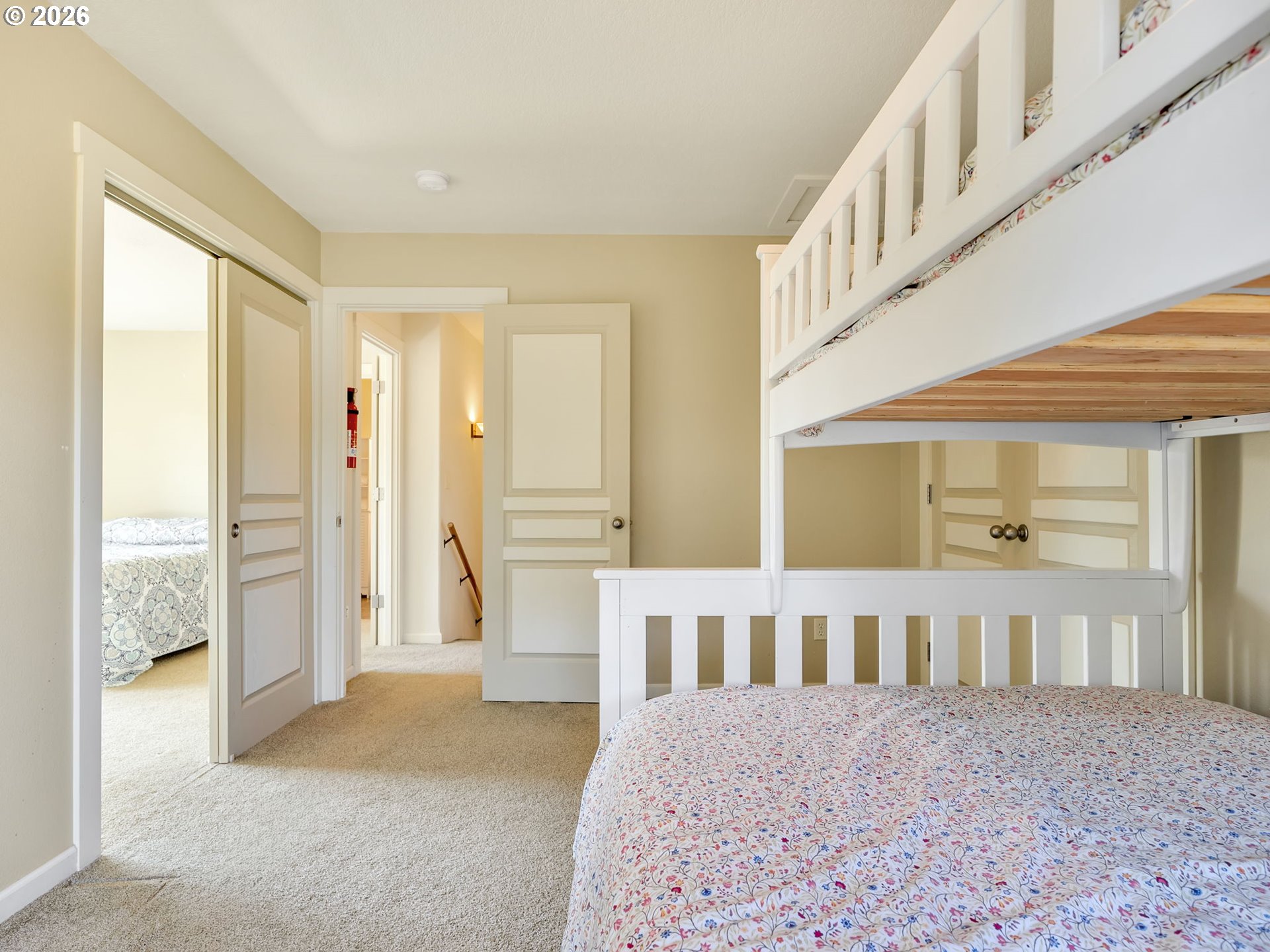 1077 Southwest Ridge Road Warrenton, OR 97146 - Photo 40 of 46 a view of a bedroom with wooden floor and windows