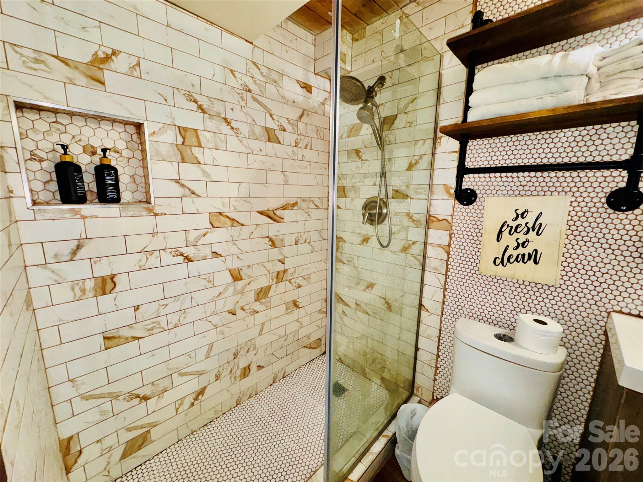201 South Hoskins Road, Unit 132 Charlotte, NC 28208 - Photo 11 of 20 a white toilet sitting next to a shower curtain