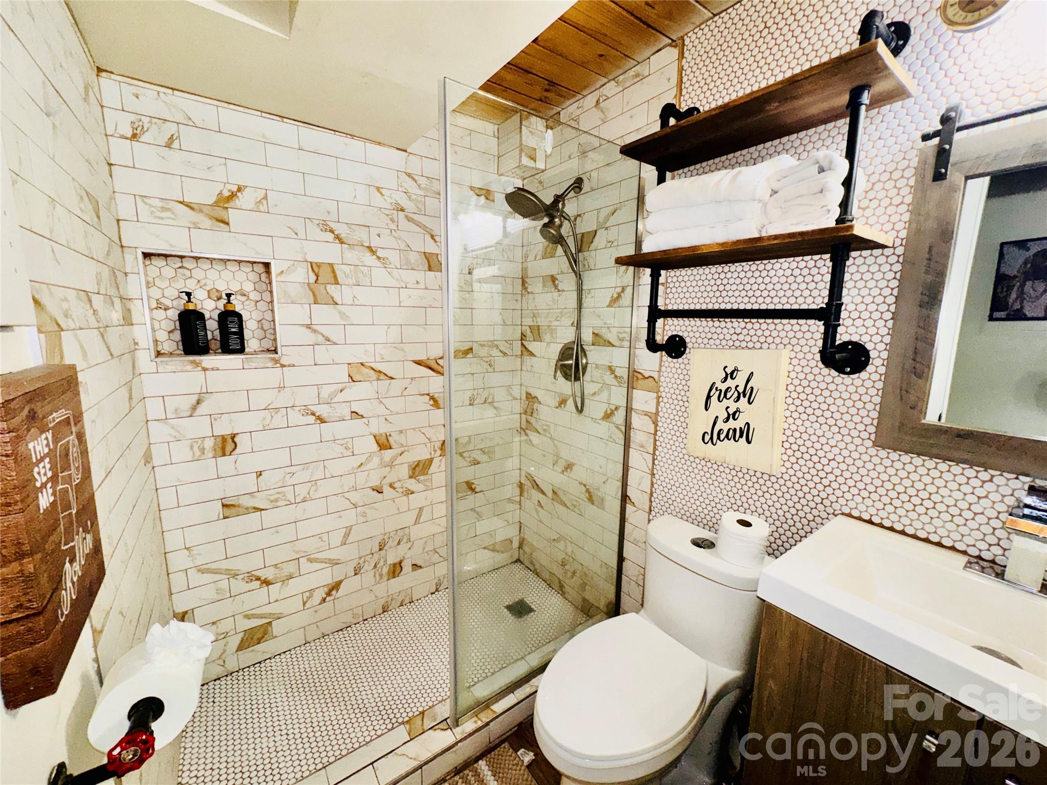 201 South Hoskins Road, Unit 132 Charlotte, NC 28208 - Photo 12 of 20 a bathroom with a toilet sink and shower