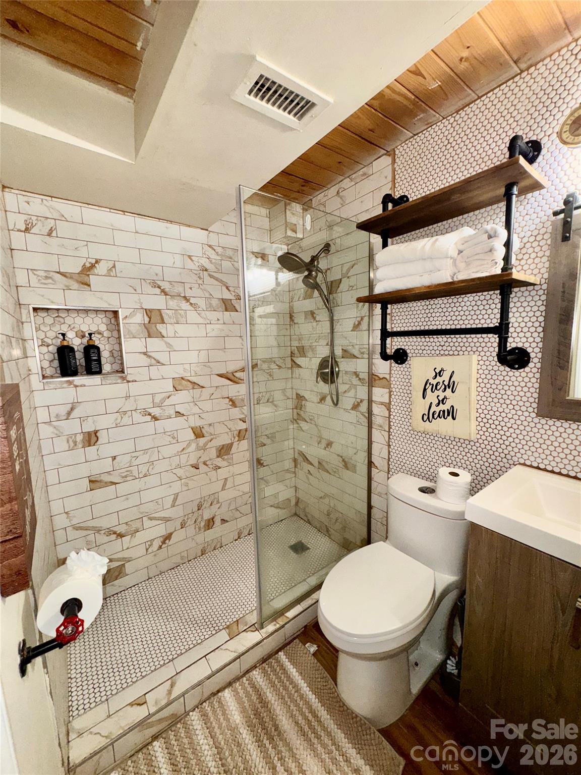 201 South Hoskins Road, Unit 132 Charlotte, NC 28208 - Photo 13 of 20 a bathroom with a toilet and a shower