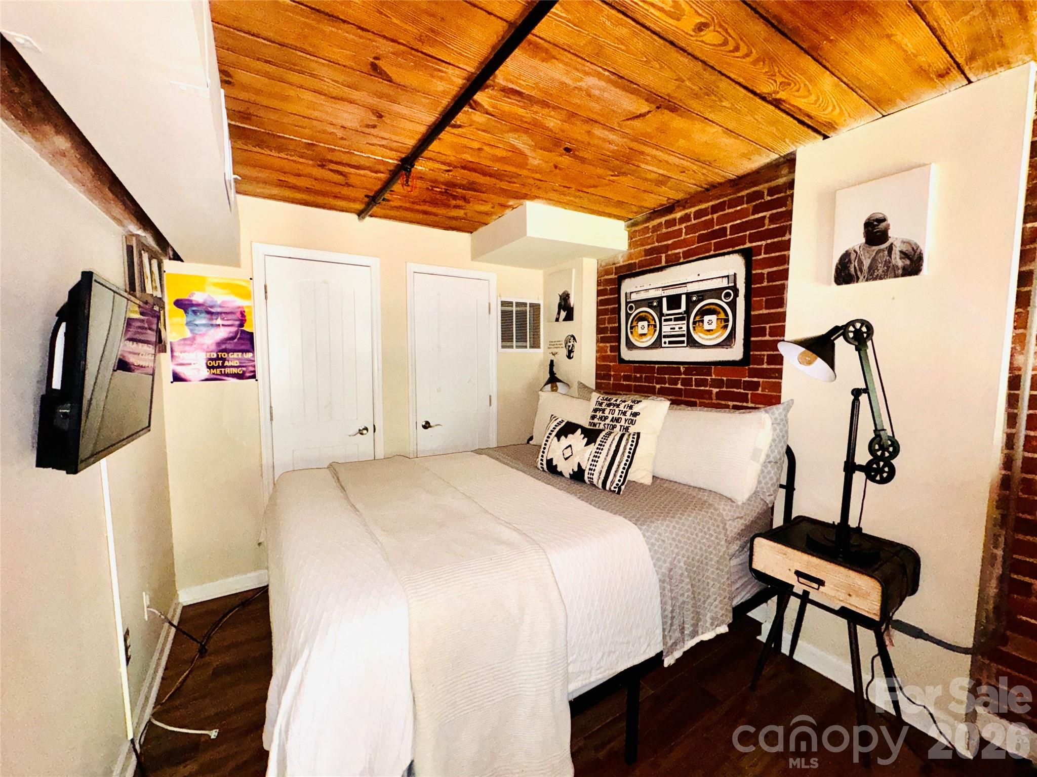 201 South Hoskins Road, Unit 132 Charlotte, NC 28208 - Photo 14 of 20 a bed room with a bed and a chair