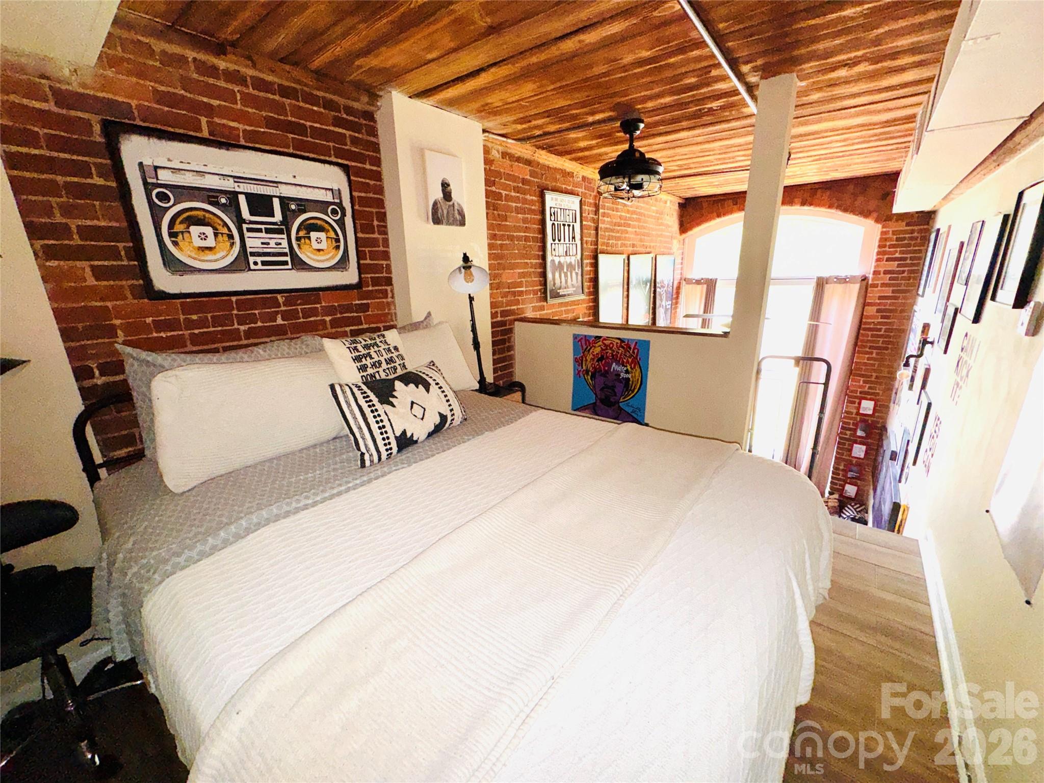 201 South Hoskins Road, Unit 132 Charlotte, NC 28208 - Photo 16 of 20 a bed room with a bed and a chair