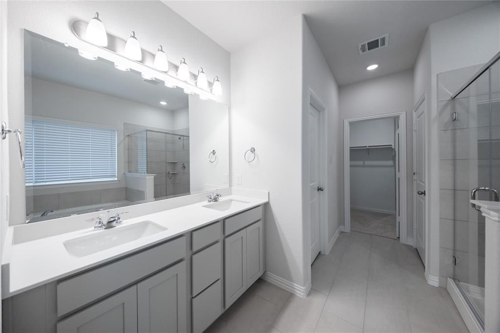 2606 Hawkins Street Anna, TX 75409 - Photo 15 of 31 a bathroom with a double vanity sink and a mirror