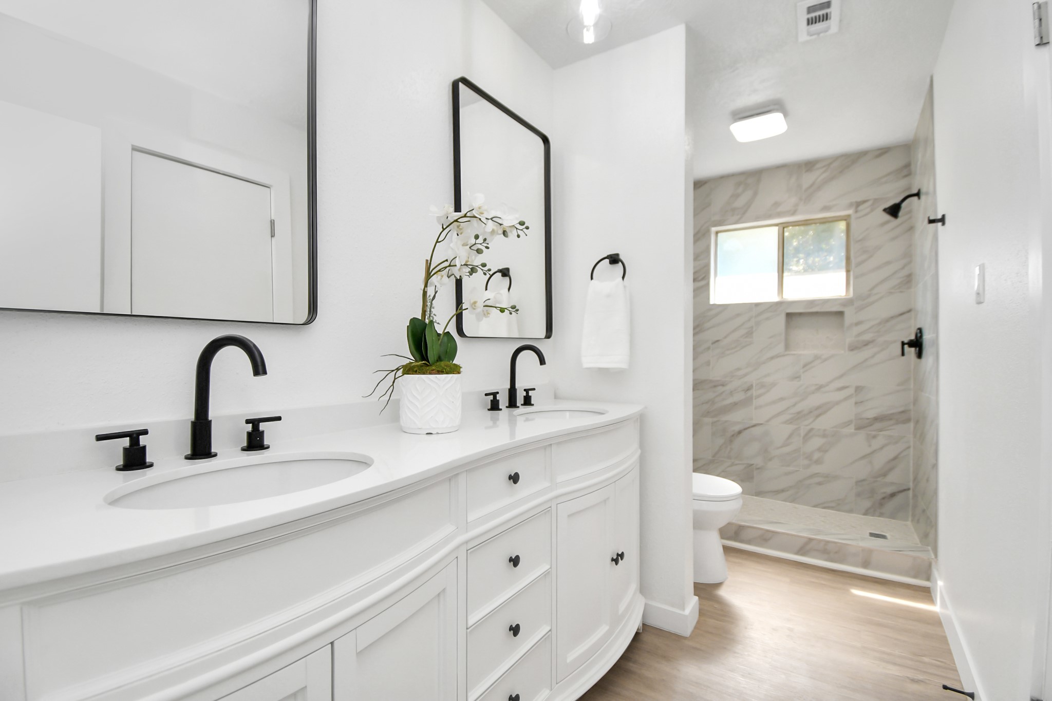 9912 Cardinal Street La Porte, TX 77571 - Photo 17 of 34 a bathroom with double vanity sink a mirror and a shower
