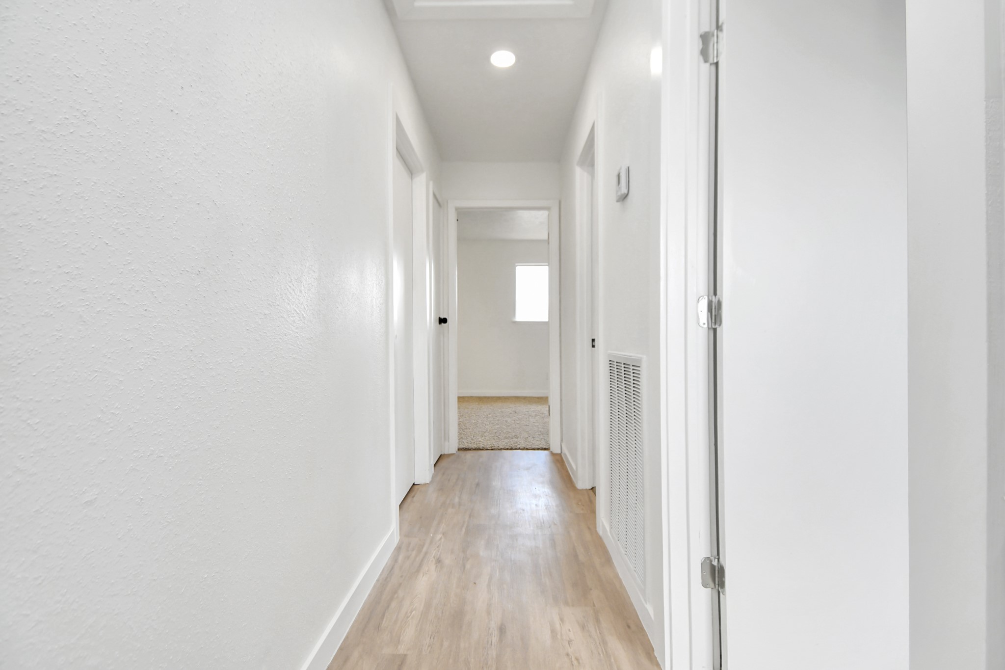 9912 Cardinal Street La Porte, TX 77571 - Photo 21 of 34 a view of a hallway with wooden floor