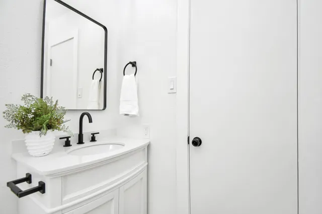 a bathroom with a toilet a window and a shower