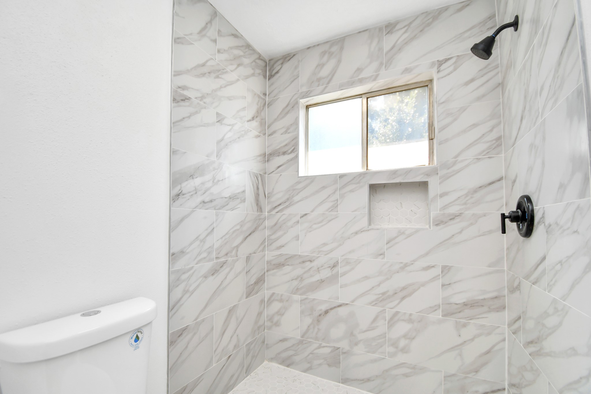 9912 Cardinal Street La Porte, TX 77571 - Photo 26 of 34 a bathroom with a toilet a window and a shower