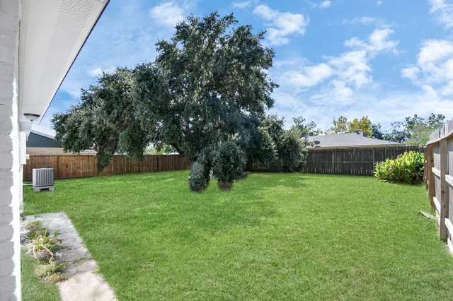a view of a backyard with large trees