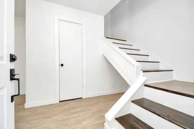 a view of entryway and hall with wooden floor
