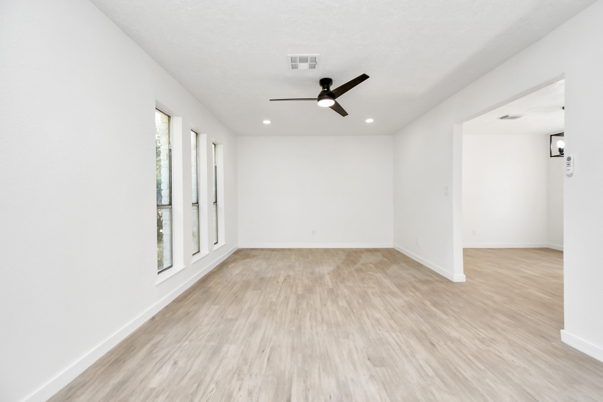 9912 Cardinal Street La Porte, TX 77571 - Photo 4 of 34 an empty room with wooden floor cabinet and windows