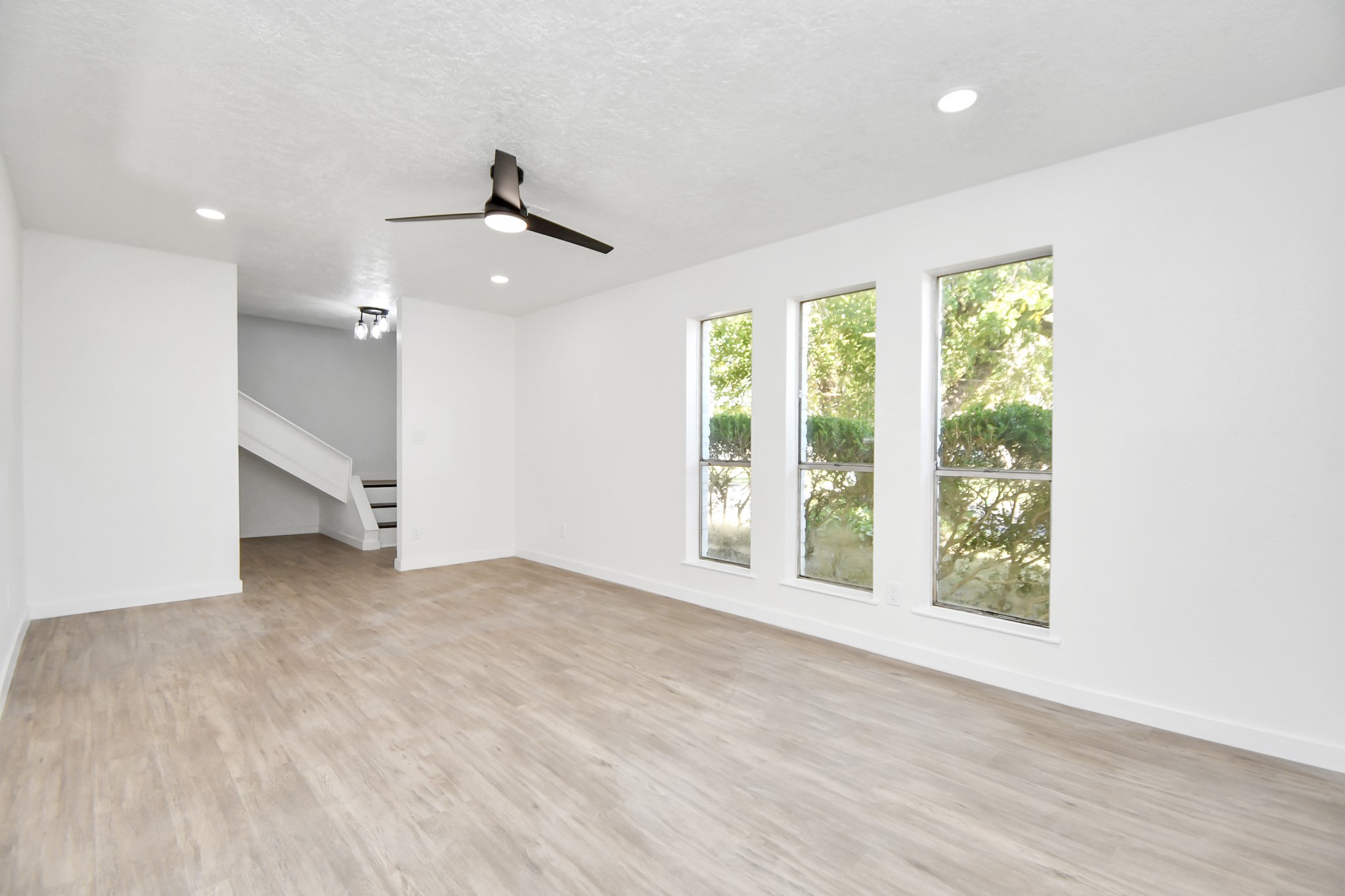 9912 Cardinal Street La Porte, TX 77571 - Photo 6 of 34 an empty room with large windows and ceiling fan