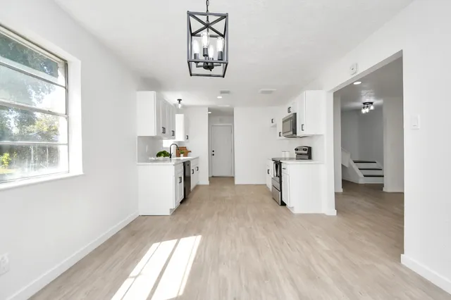a kitchen with stainless steel appliances a refrigerator and a stove top oven