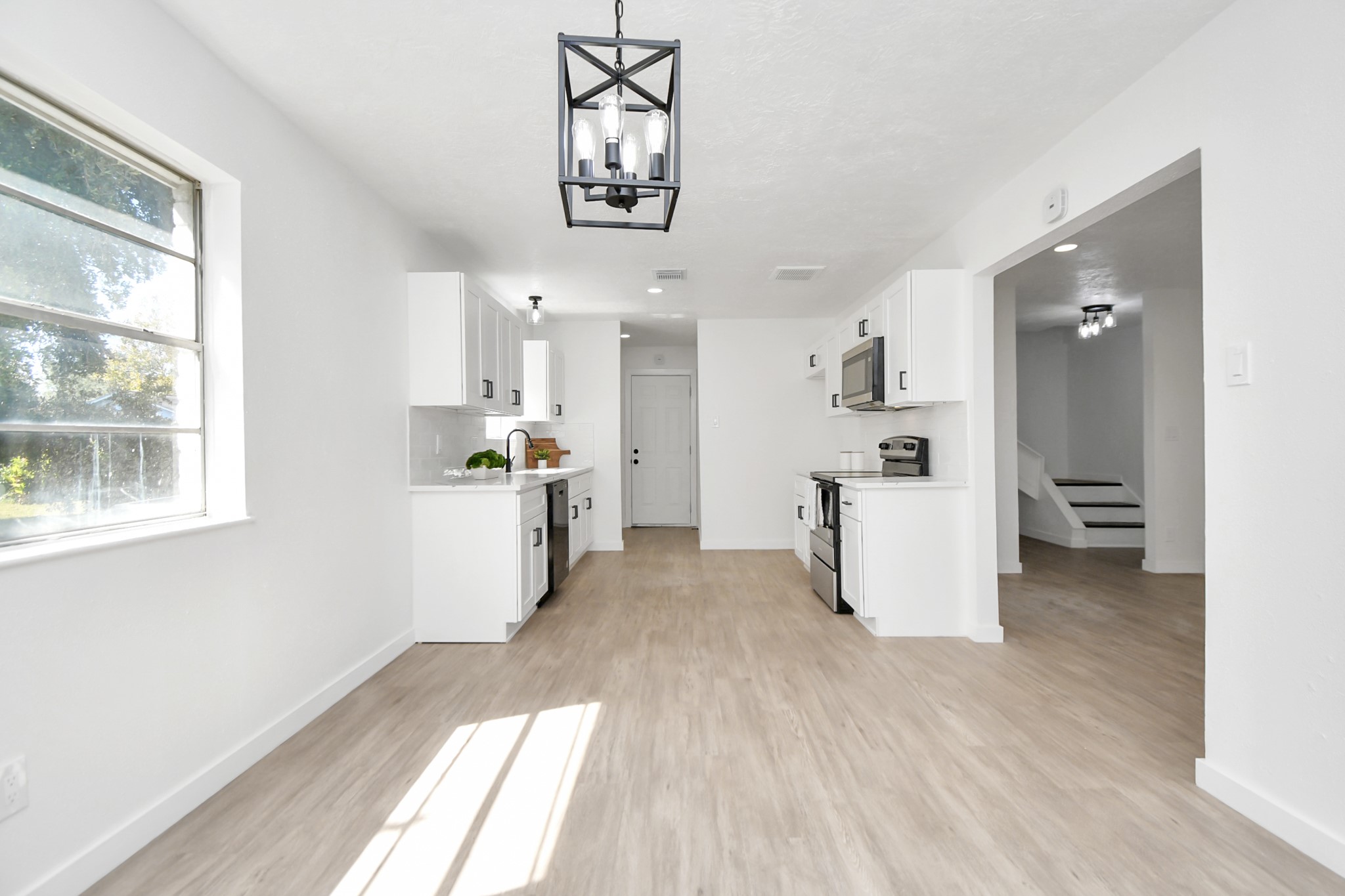 9912 Cardinal Street La Porte, TX 77571 - Photo 10 of 34 a kitchen with stainless steel appliances a refrigerator and a stove top oven