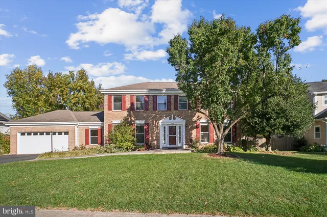 a view of a hallway with wooden floor and stairs