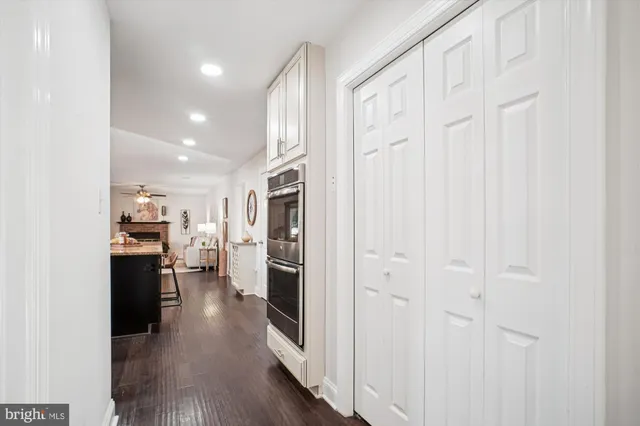 a living room with furniture a fireplace and a large window