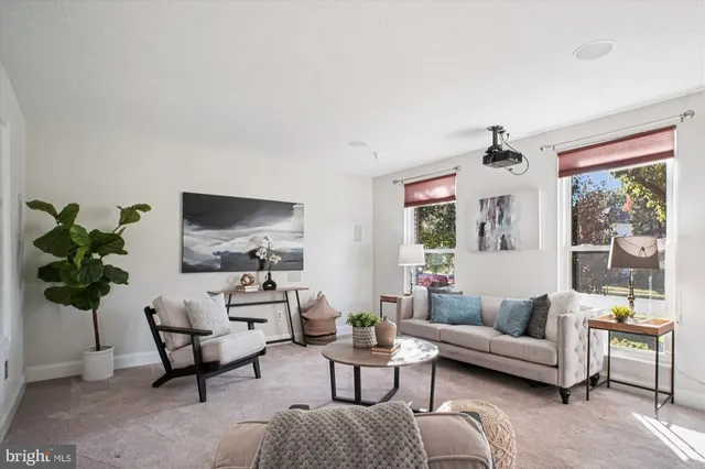 a dining room with furniture a rug and a window