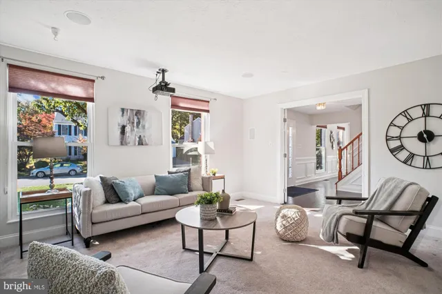 a view of a dining room with furniture a chandelier and wooden floor