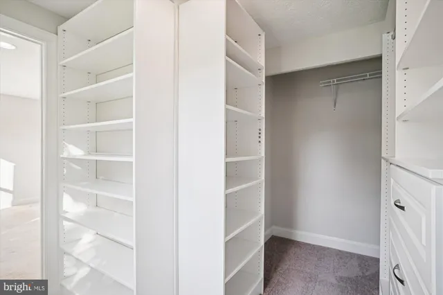 a spacious bathroom with a granite countertop sink a toilet and shower