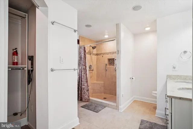 a bathroom with a sink vanity granite and a mirror