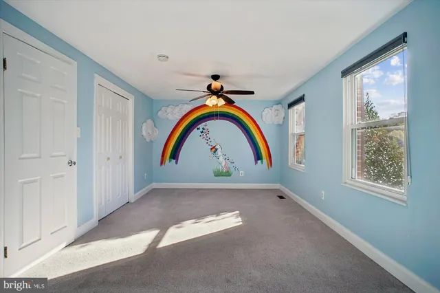 a bathroom with a double vanity sink mirror and toilet