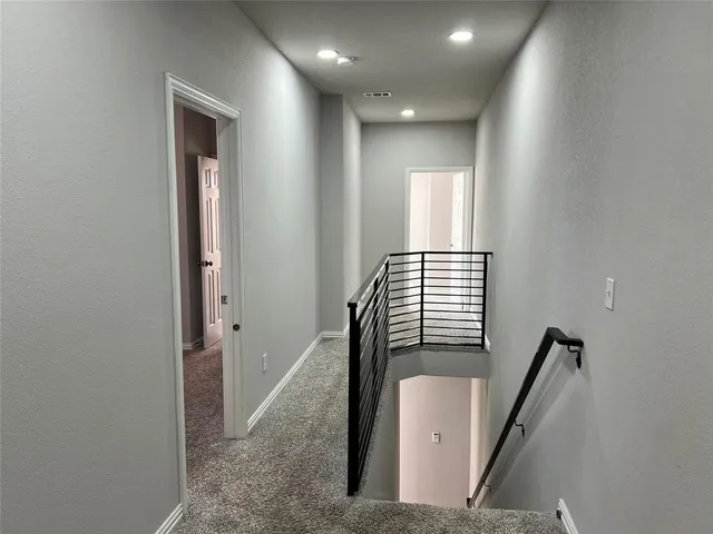 an empty room with a window and a ceiling fan