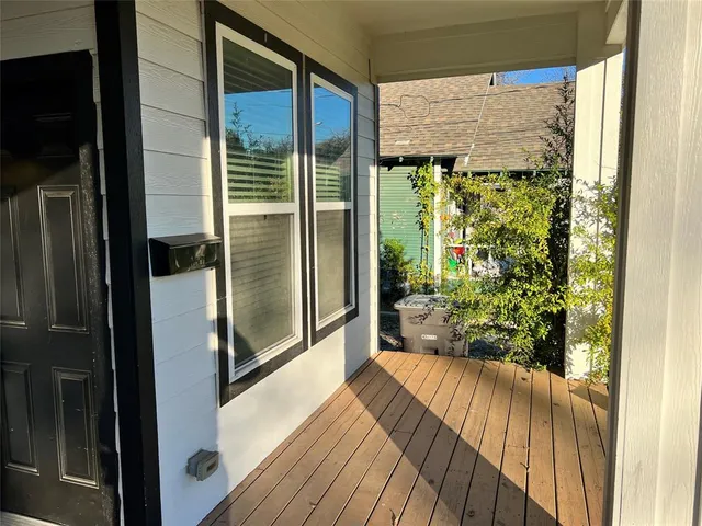 a view of a glass door with wooden floor