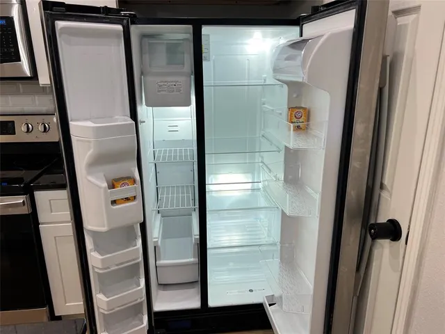 a bathroom with a glass door shower and vanity