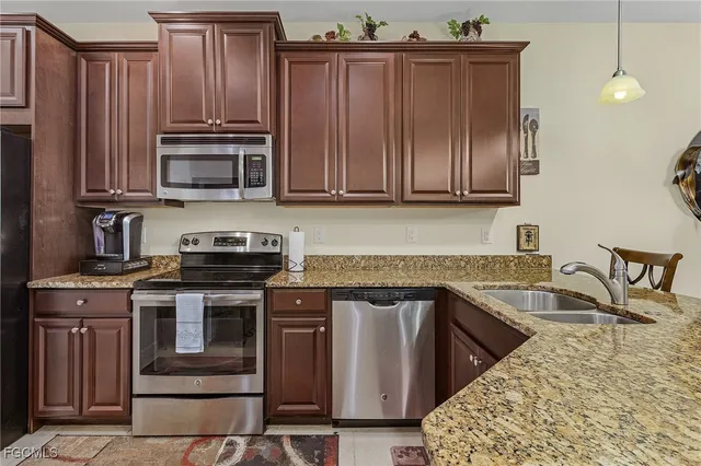 a kitchen with granite countertop a stove and a sink