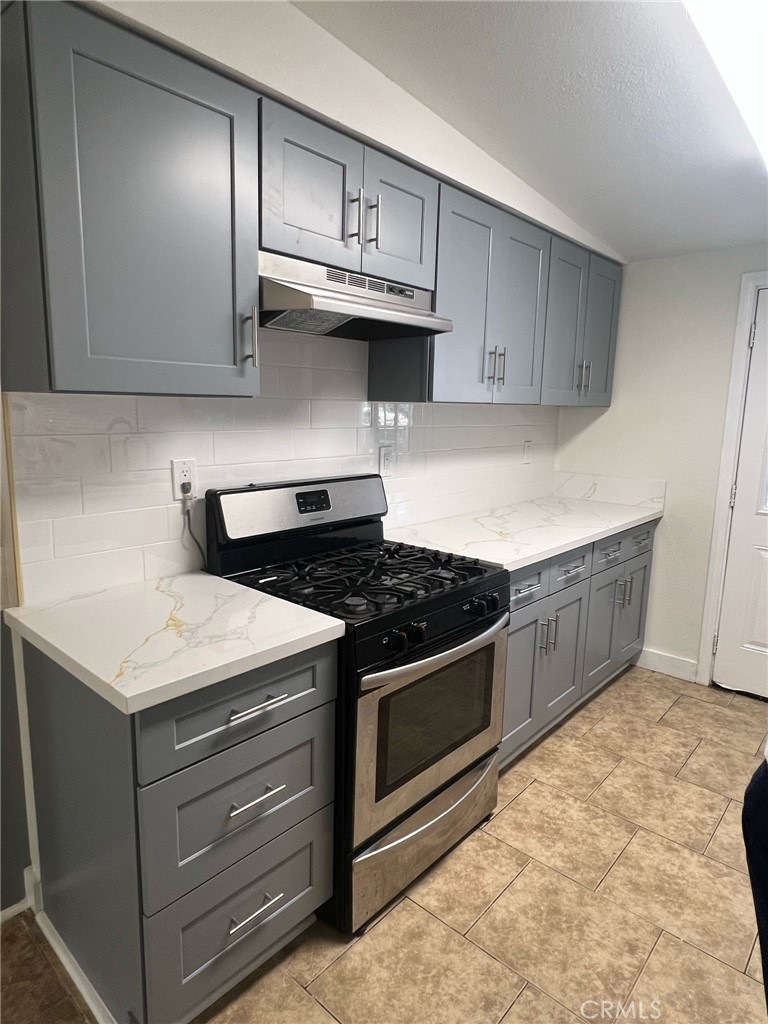 18222 9th Street Bloomington, CA 92316 - Photo 12 of 22 a kitchen with stainless steel appliances granite countertop a stove and a sink