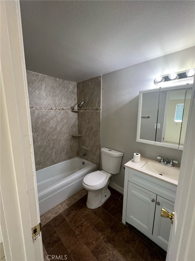18222 9th Street Bloomington, CA 92316 - Photo 4 of 22 a bathroom with a sink toilet vanity and tub